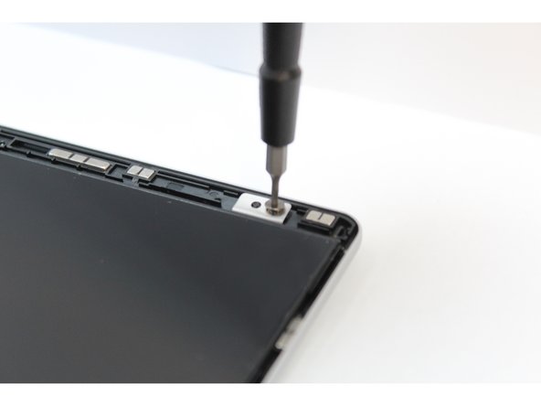 Using the T5 bit in the Framework Screwdriver screw the four fasteners into place.