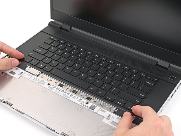 Slide the top lip of the Keyboard underneath the ventilation plate and lay the Keyboard down flat to let the magnets pull it into place.