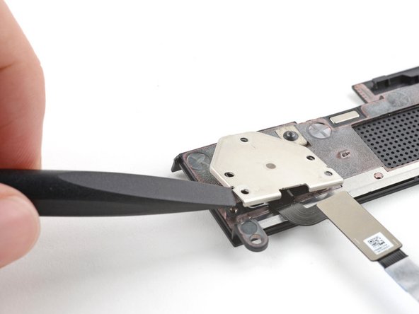 Use the flat end of your Framework Screwdriver to lift the fingerprint reader cover and remove it.