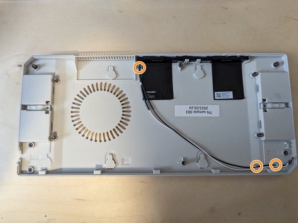 The cables connecting the antenna to the WiFi Card are routed under the Mainboard and should be fitted into the cable guides.
