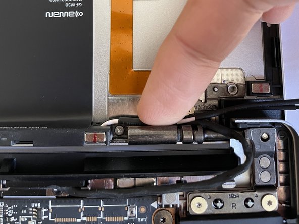 Peel away the blue backing liner on the antenna cable and stick the cable onto the hinge.