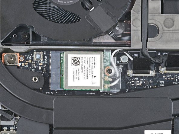 Use your Framework Screwdriver to tighten the captive T5 Torx screw securing Wi-Fi module.