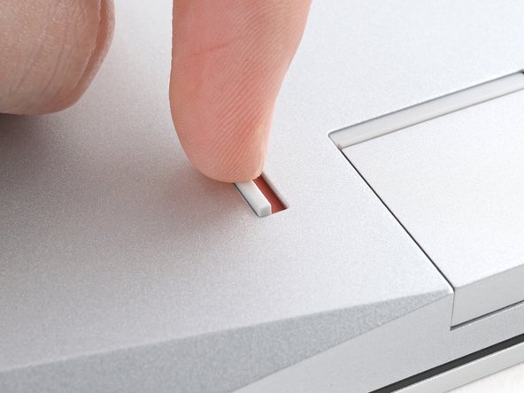 Use your finger to flip the Expansion Card latch into the unlocked position.