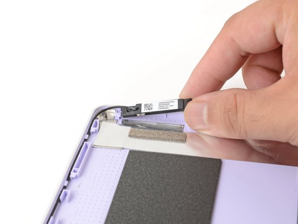 Use your fingers to lift the left antenna away from the Top Cover.