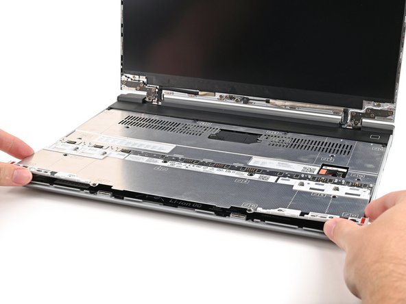 Place the Mid Plate on the laptop, making sure it sits evenly on its alignment pegs.