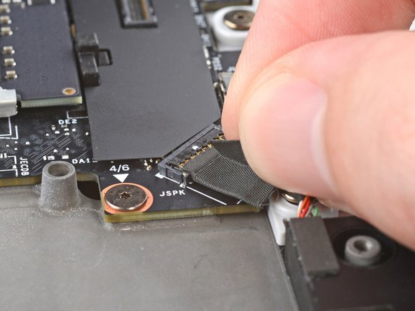 Press the speaker cable connector onto its socket to connect it.