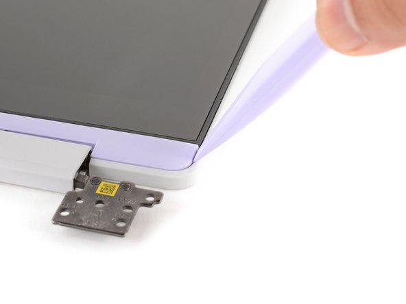 The Display Cover is held in place with magnets along its top edge and clips along its remaining edges.