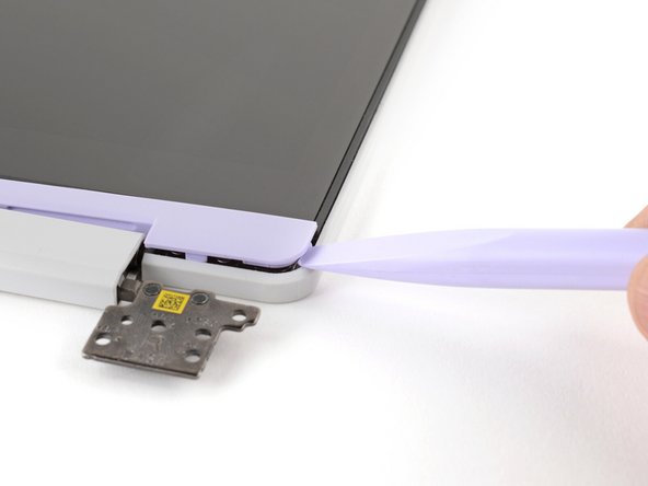 Use the flat end of your Framework Screwdriver to pry up the right edge of the Display Cover.