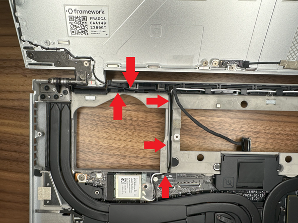 Route the Black Antenna Cable through the left hinge; placing it in the front of the guided channel.