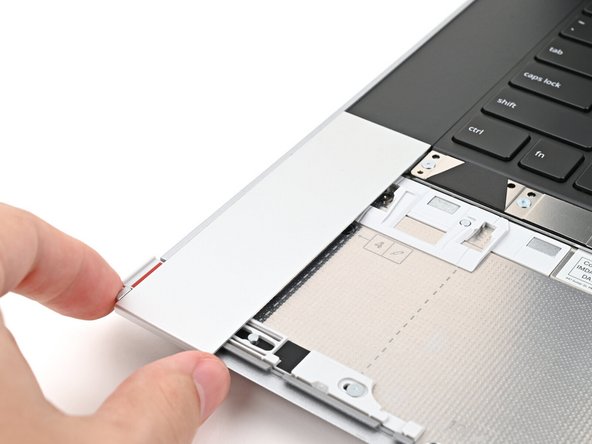 Place the Touchpad Spacer over its spot on the laptop with the bottom edge overhanging slightly.