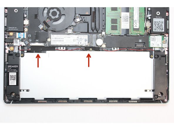 Locate the other piece of black tape and carefully peel it back to reveal the black and red speaker wires.