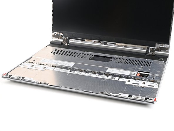 Place the Mid Plate on the laptop, making sure it sits evenly on its alignment pegs.
