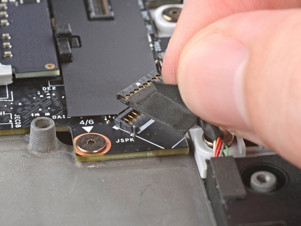 Press the speaker cable connector onto its socket to connect it.