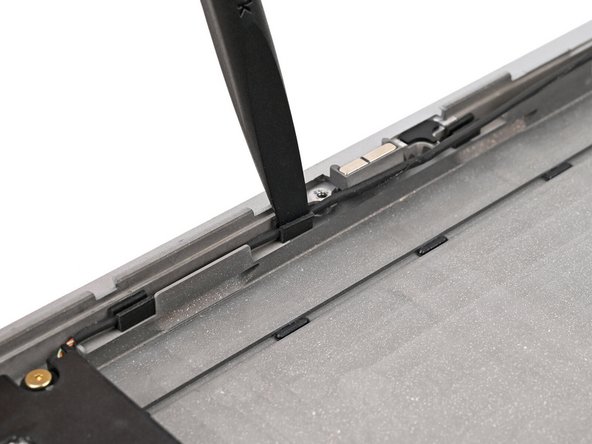 Use the flat end of your Framework Screwdriver to push the speaker cable back into its clips along the bottom edge of the laptop.