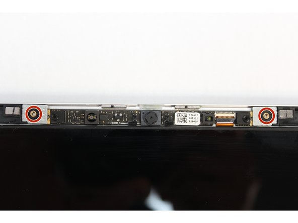Using the T5 Bit in the Framework Screwdriver screw in both fasteners.