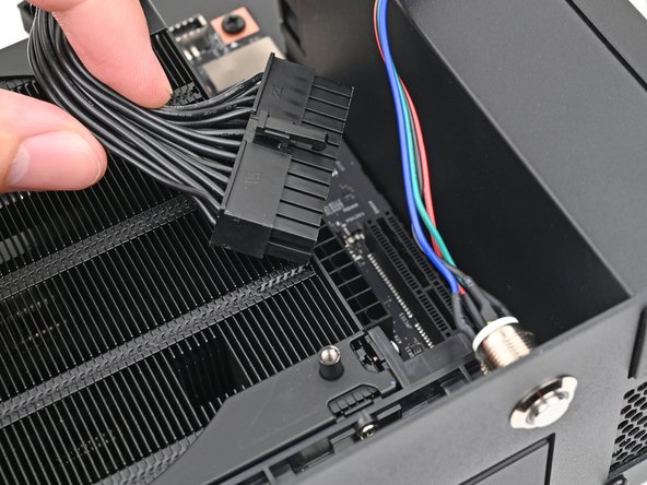 Orient the main power supply cable so its clip is facing away from the heatsink.