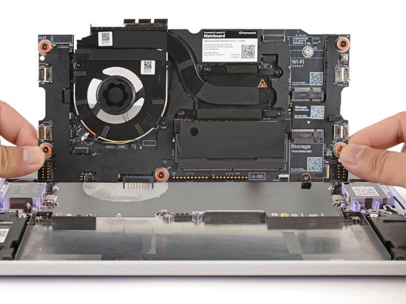 Use your fingers to grab the Mainboard by its edges.