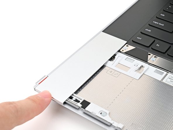 Slide the Touchpad Spacer towards the top of the laptop to secure it.