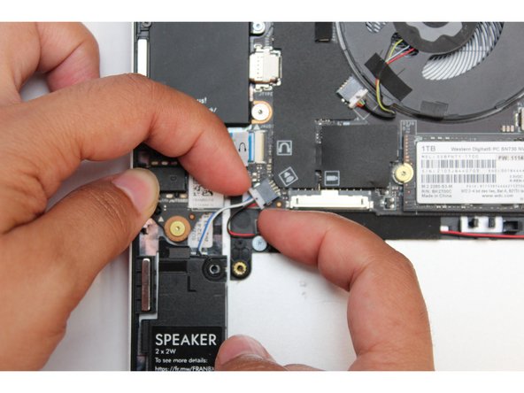 Using your fingernails disconnect the speaker connector from the Mainboard by gripping the edges of the connector and pulling straight out.