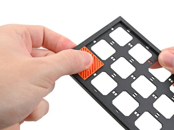 Use your fingers to press the tile into the slot and engage the clips.
