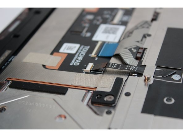 Grip the black pull tab on the cable and pull it straight out.