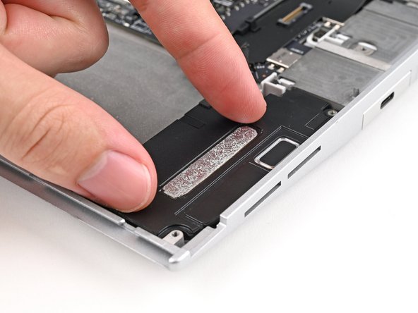 Align the speakers over their alignment pegs and press them down into place.