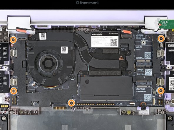 Use your Framework Screwdriver to loosen the five captive T5 Torx screws securing the Mainboard.