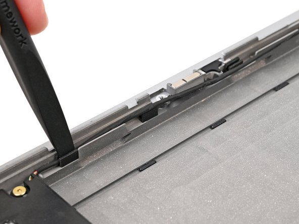 Use the flat end of your Framework Screwdriver to push the speaker cable back into its clips along the bottom edge of the laptop.