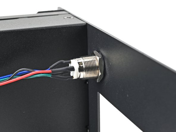 While holding the power button in place, tighten the nut over the threads of the power button until it's snug.