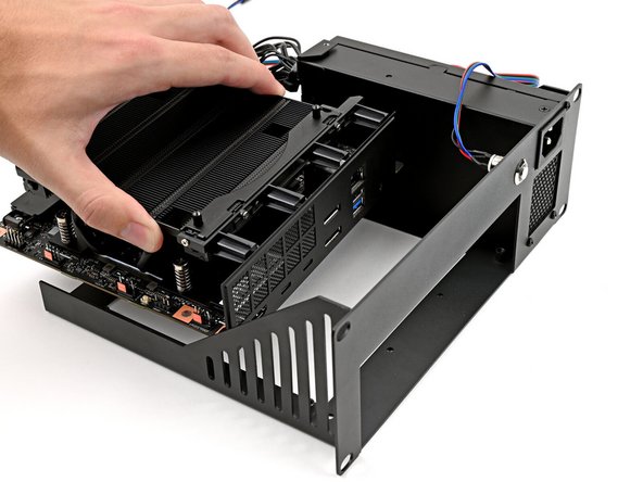 Grab the Mainboard by its heatsink and slide it into the Tray with its I/O ports facing the front.
