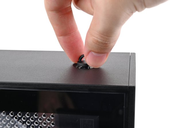 Insert the top panel screw into its hole and twist clockwise until it feels snug.