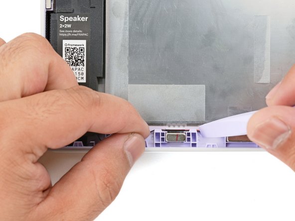 Use your Framework Screwdriver to loosely screw the left speaker in place.