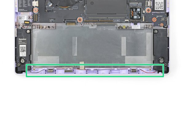 Starting near the left speaker, use your fingers and your Framework Screwdriver to carefully press and guide the speaker wire back into its channel.