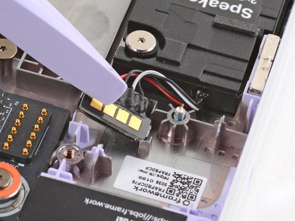 Use the flat end of your Framework Screwdriver to press the speaker connector into its recess.