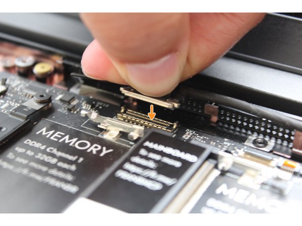Hold the pull tab on the Webcam Cable and connect it into the Mainboard by aligning the pins from the cable with the socket pins on the Mainboard.