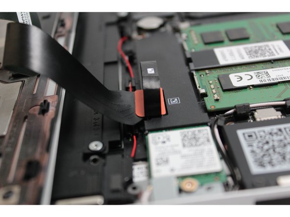 Using slight force, connect the Touchpad Cable by aligning it to the socket on Mainboard.  You should hear it click into place once properly connected.