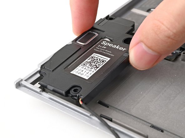 Align the speakers over their alignment pegs and press them down into place.