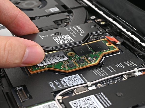 Place the LPCAMM2 Memory Cover on top of the memory, making sure its screws align with the screw holes.