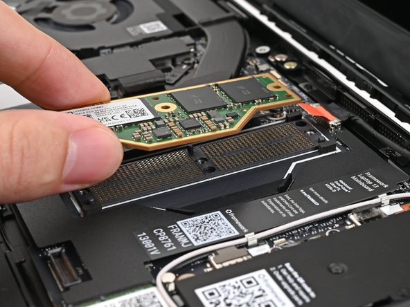 Place the LPCAMM2 module on top of the Interposer, making sure it slots into its alignment pegs.