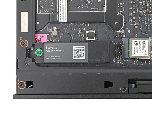Use your Framework Desktop Screwdriver to tighten the captive T5 Torx screw securing the heat spreader.