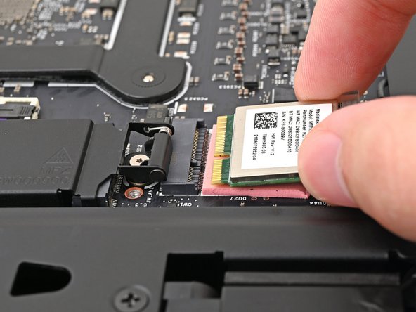 Grip the Wi-Fi module by its edges and pull it straight out of its socket.