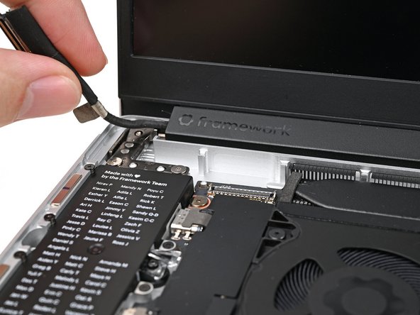 Place the Display eDP Cable into its slot on the Bottom Cover.