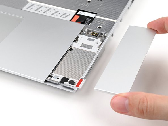 Lift the Touchpad Spacer off the laptop and remove it.
