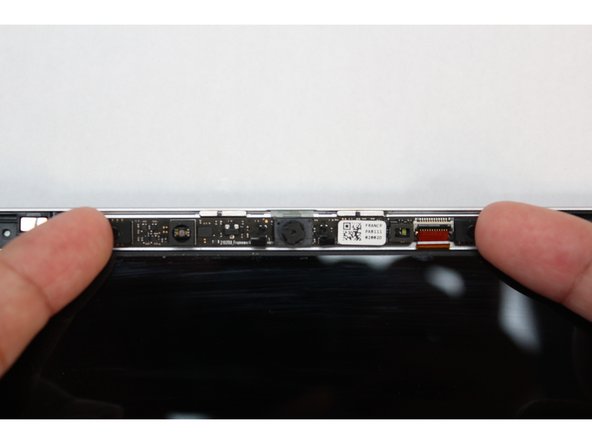 Lift the module out of the cover by handling the module only by the edges.