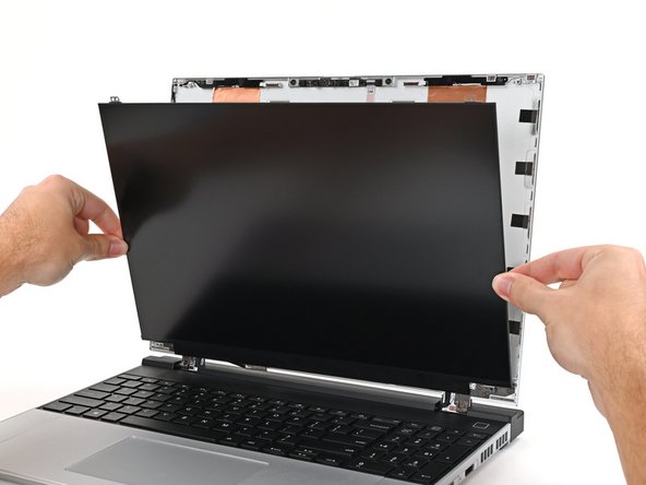 Align the display with its alignment pegs and place it on the Top Cover.