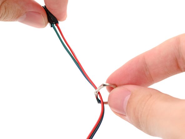 Thread the hexagonal nut over the power button cable and slide it down the length of the cable.