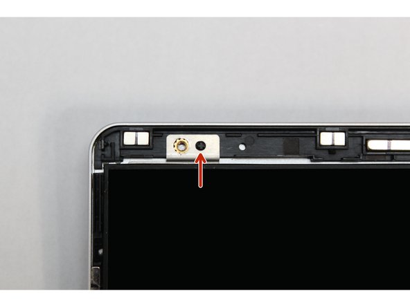 There are four alignment pins located on the Top Cover. They are located right next to the four fastener slots. Place the silver brackets connected to Display directly over the pins.