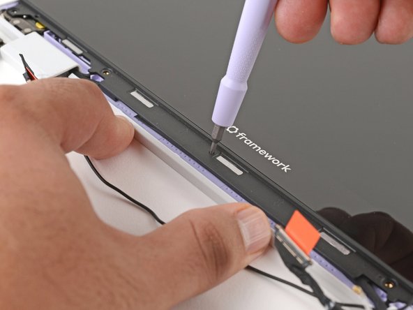 Use your fingers to hold the bottom edge of the Top Cover in place.