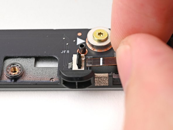 Use your fingers to grip the brown pull tab and slide the fan cable straight into its socket.