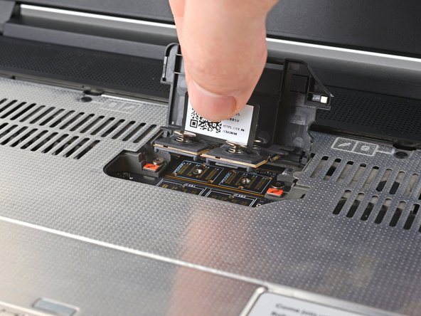 Lift the interposer by its pull tab and remove it.